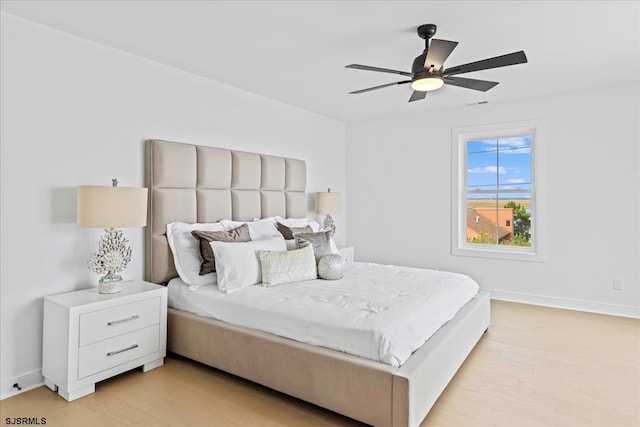 bedroom with light wood-type flooring and ceiling fan