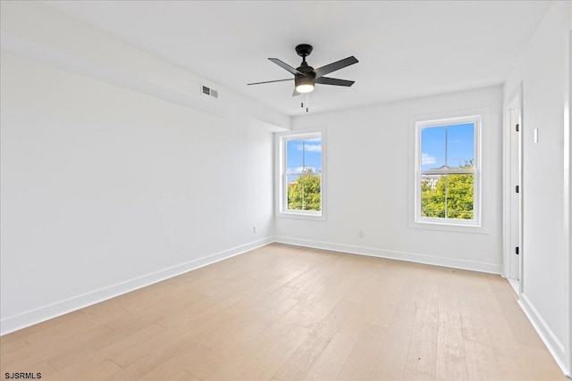 empty room with ceiling fan and light hardwood / wood-style floors