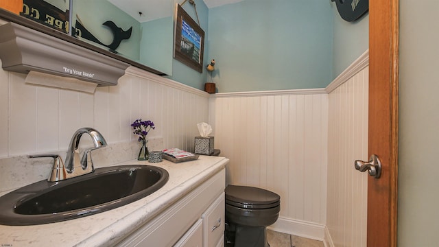 bathroom with vanity, tile patterned flooring, and toilet