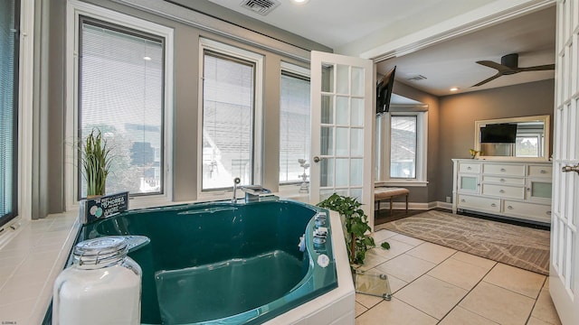 bathroom featuring ceiling fan and tile patterned flooring