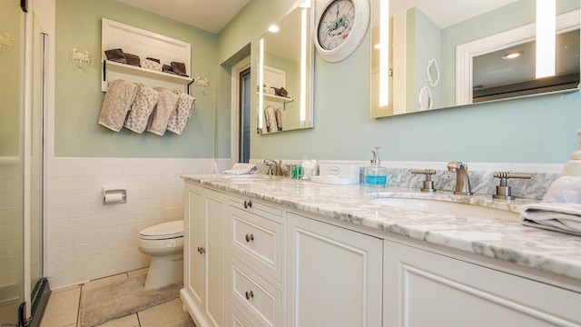 bathroom featuring tile walls, tile patterned flooring, vanity, an enclosed shower, and toilet