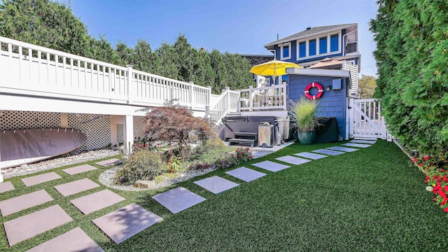 view of yard with a hot tub and a deck