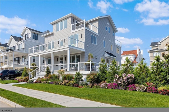 view of front of home featuring a front yard and a porch