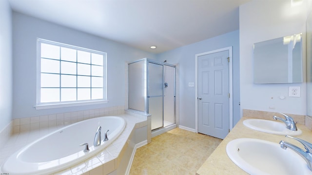 bathroom with vanity and shower with separate bathtub