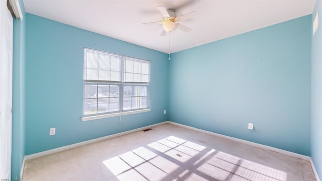 carpeted empty room featuring ceiling fan