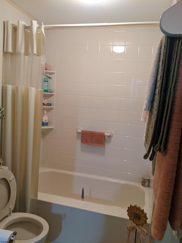 bathroom featuring shower / bathtub combination with curtain and toilet