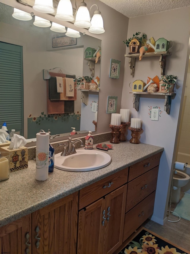 bathroom featuring vanity and a textured ceiling