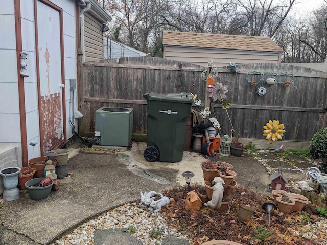 view of yard featuring central AC unit and fence