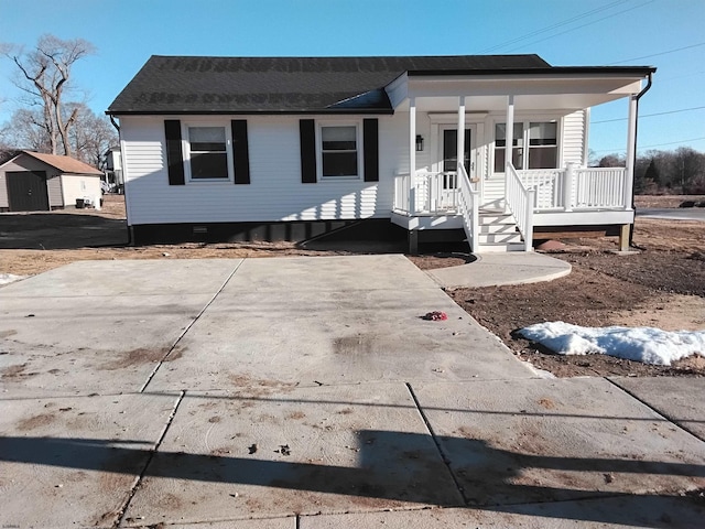 view of front facade with a porch and a shed