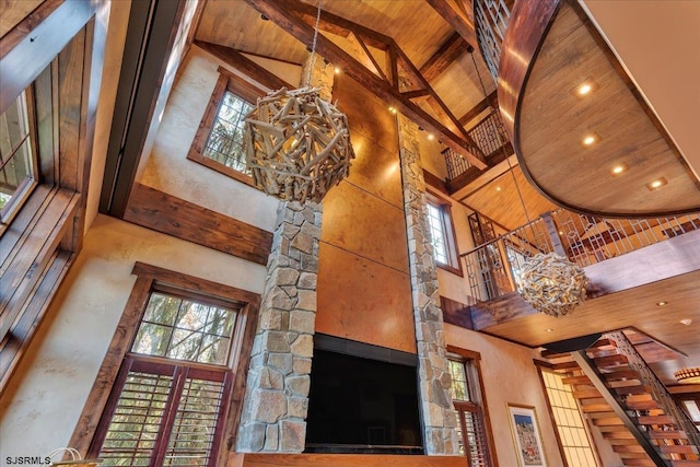 room details with an inviting chandelier, beam ceiling, and wooden ceiling