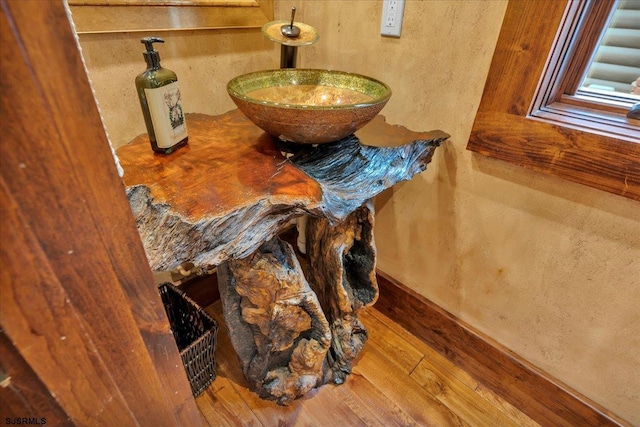 interior details with sink and wood-type flooring