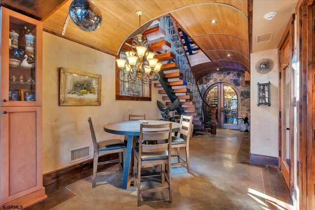 dining space with a notable chandelier, vaulted ceiling, and wooden ceiling