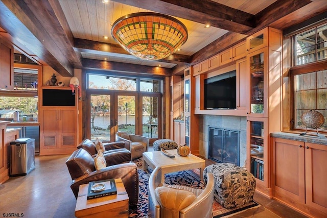 living room featuring wood ceiling, wooden walls, a fireplace, french doors, and beamed ceiling