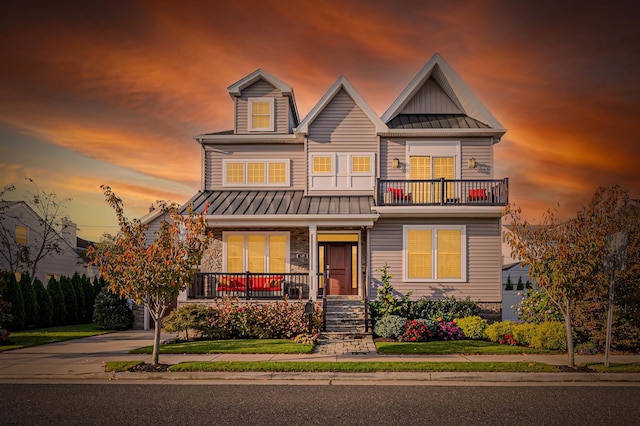 view of front of home with a balcony and a porch