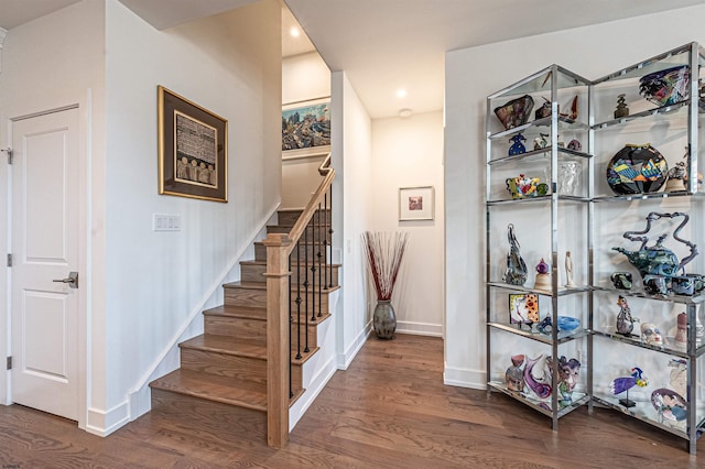 staircase with wood-type flooring