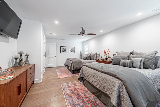 bedroom with ceiling fan and light hardwood / wood-style floors