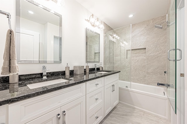 bathroom with vanity and shower / bath combination with glass door