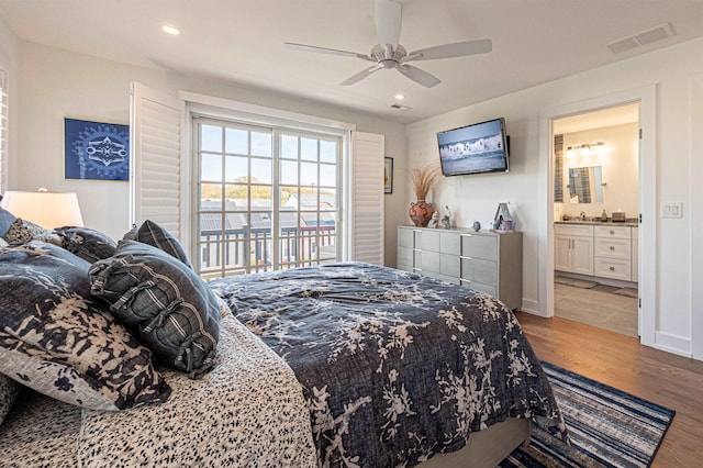 bedroom featuring ensuite bathroom, light wood-type flooring, access to outside, and ceiling fan