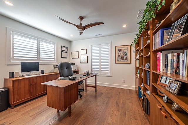 office space with plenty of natural light, hardwood / wood-style floors, and ceiling fan