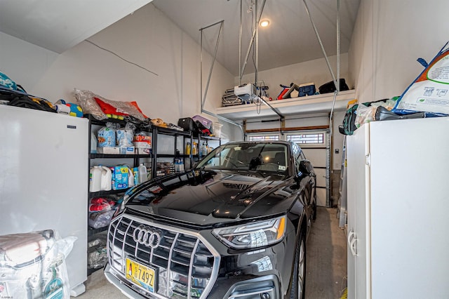 garage with fridge and a garage door opener