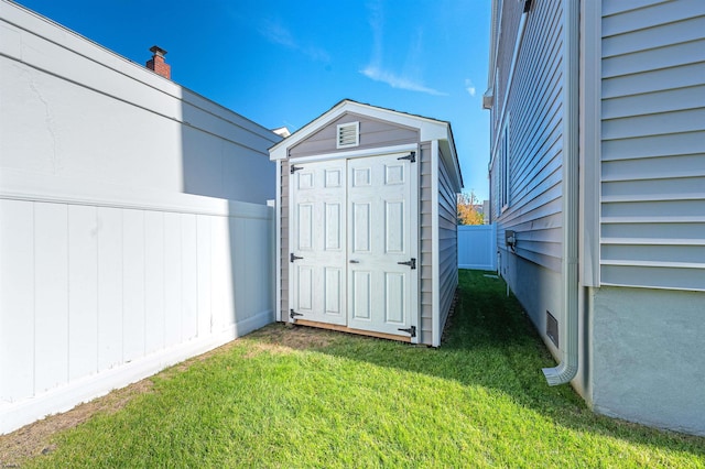 view of outbuilding featuring a yard