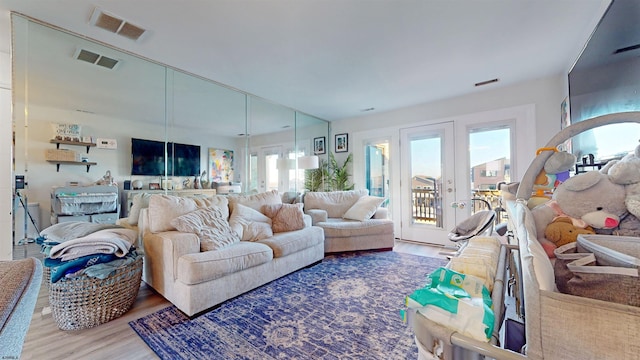 living room with hardwood / wood-style floors and french doors