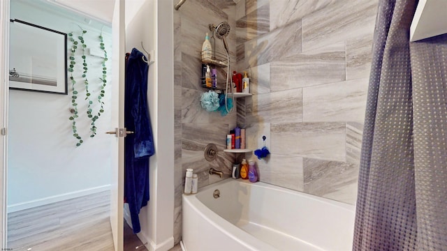 bathroom featuring shower / bathtub combination with curtain and hardwood / wood-style floors