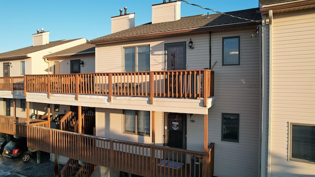 back of house featuring a balcony