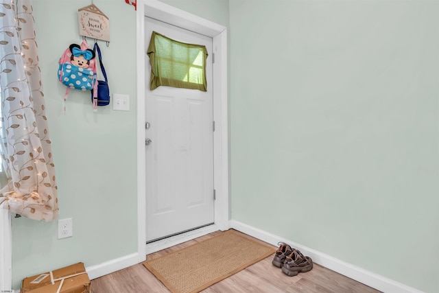 entryway with hardwood / wood-style floors