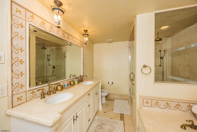 bathroom with tile patterned flooring, vanity, a shower with door, and toilet