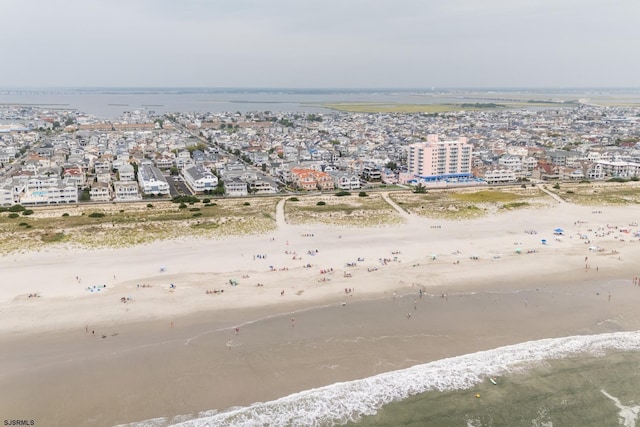 bird's eye view featuring a beach view and a water view