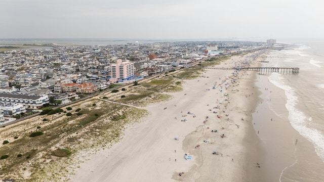 birds eye view of property featuring a view of the beach and a water view