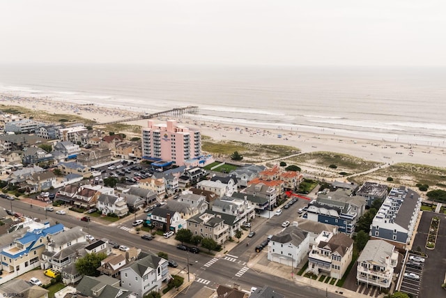 birds eye view of property featuring a view of the beach and a water view