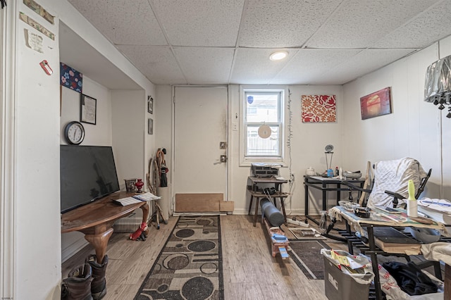 interior space with hardwood / wood-style floors and a drop ceiling