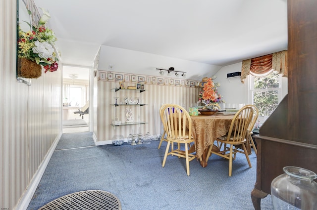 carpeted dining area featuring lofted ceiling