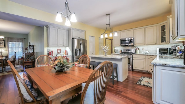 dining space with dark hardwood / wood-style floors