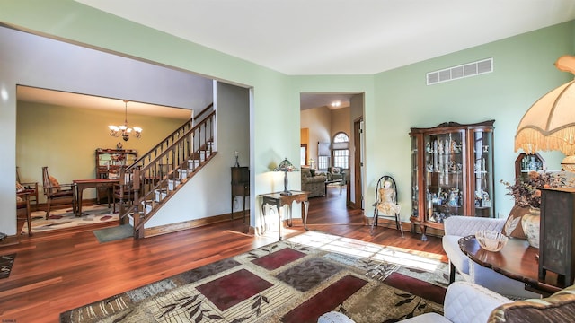 living room featuring dark hardwood / wood-style flooring and a chandelier