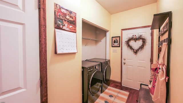 laundry area featuring dark wood-type flooring and washing machine and clothes dryer