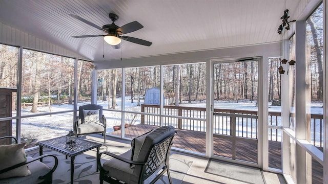 sunroom / solarium featuring ceiling fan and lofted ceiling