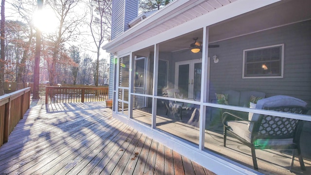 deck with ceiling fan and a sunroom