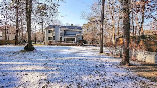 snow covered property featuring a deck