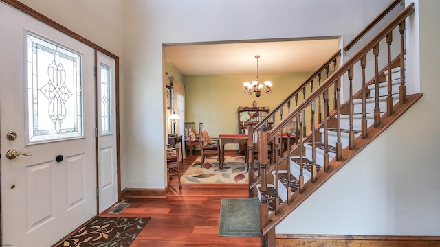 foyer featuring a healthy amount of sunlight, dark hardwood / wood-style floors, and a notable chandelier