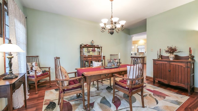 home office with an inviting chandelier and hardwood / wood-style flooring