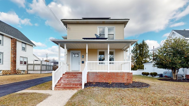 view of front of house with a porch and a front lawn