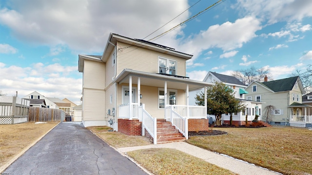 view of front of house featuring a porch and a front lawn