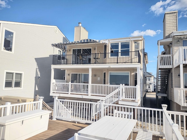 back of property featuring a balcony