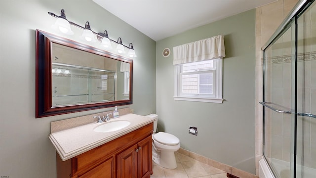 full bathroom featuring enclosed tub / shower combo, vanity, toilet, and tile patterned flooring