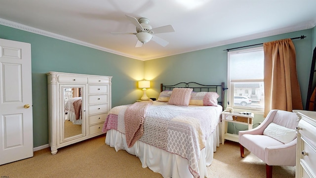 carpeted bedroom with crown molding and ceiling fan