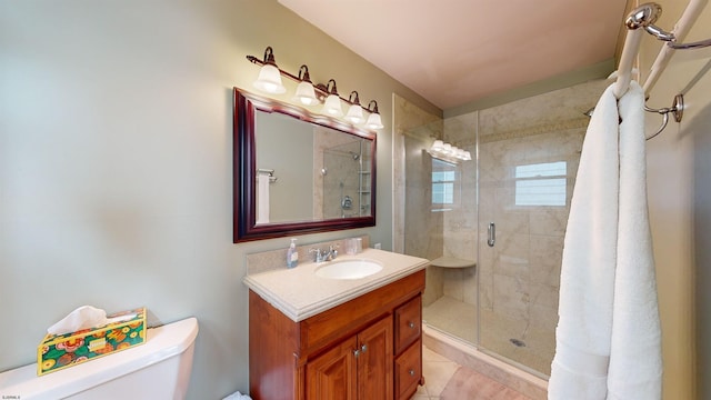 bathroom featuring vanity, toilet, tile patterned floors, and walk in shower