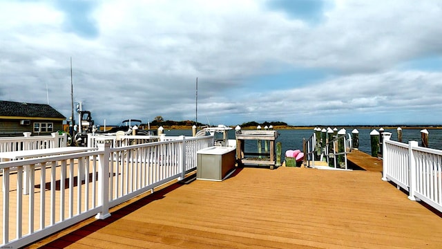 deck with a water view and a boat dock